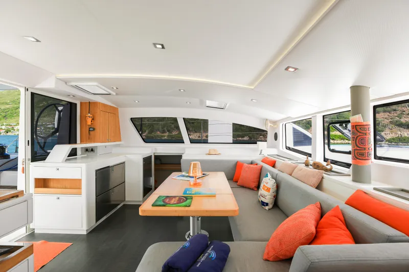 Pom III Yacht Photos Pics Luxurious interior of 2018 Outremer 5X catamaran with modern design and vibrant accents.