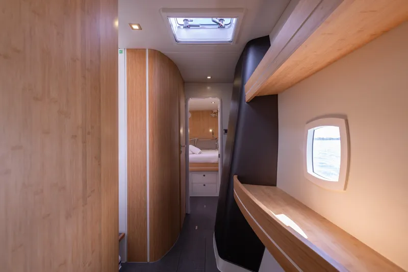 Pom III Yacht Photos Pics Luxurious interior of 2018 Outremer 5X yacht with modern wood finishes and ocean view.