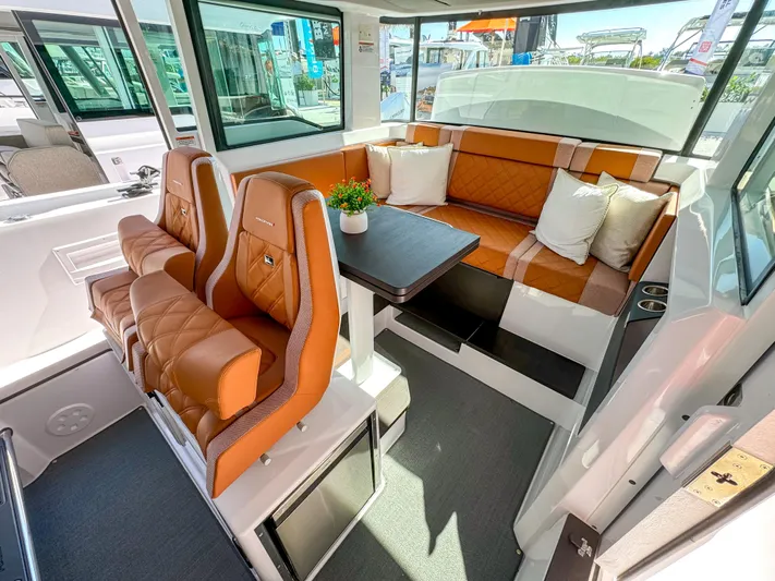  Yacht Photos Pics 2024 Axopar 37XC CROSS CABIN interior with brown leather seating and modern design.
