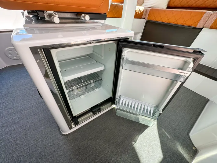  Yacht Photos Pics 2024 Axopar 37XC CROSS CABIN interior with open mini fridge, showcasing modern design.