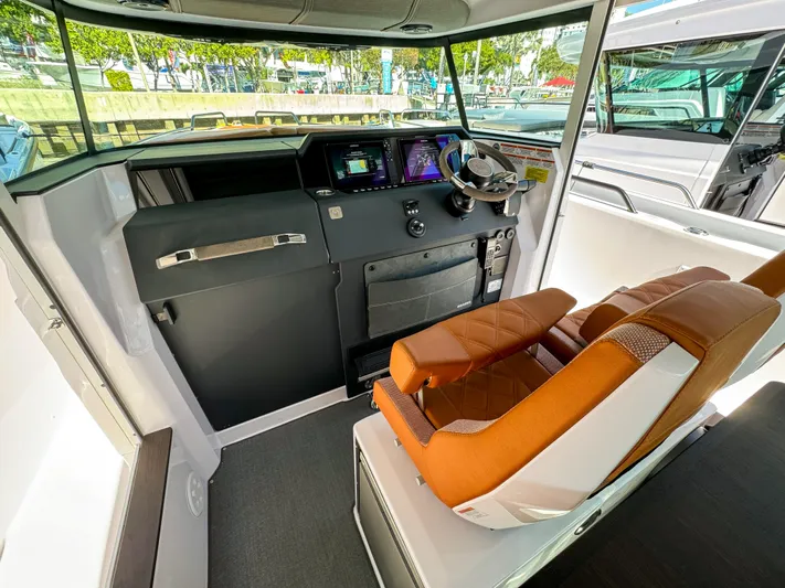  Yacht Photos Pics 2024 Axopar 37XC CROSS CABIN interior with modern helm and luxurious seating.