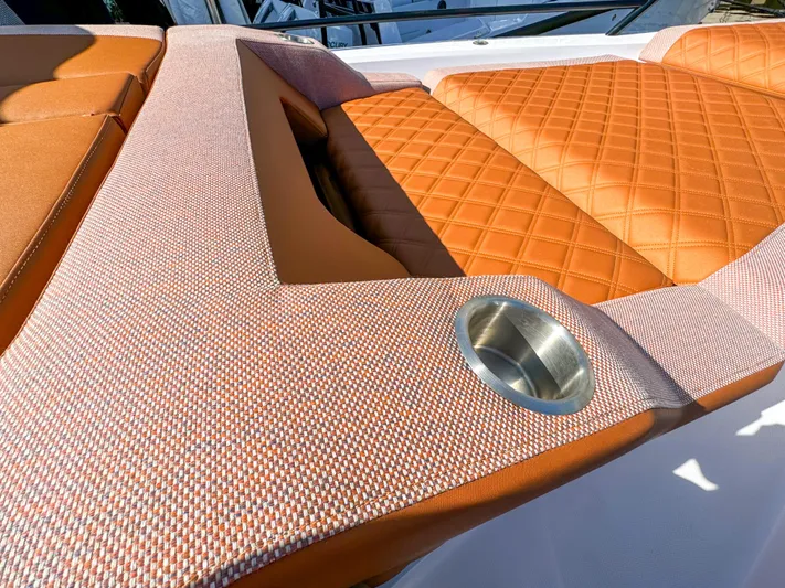  Yacht Photos Pics 2024 Axopar 37XC CROSS CABIN interior with orange quilted seating and cup holder.