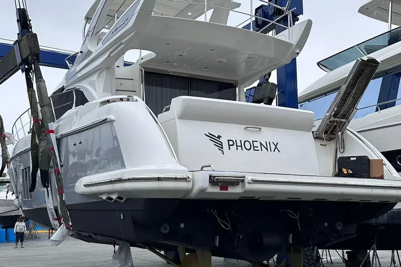  Yacht Photos Pics 2014 Azimut 54 yacht named Phoenix in a boatyard, rear view.