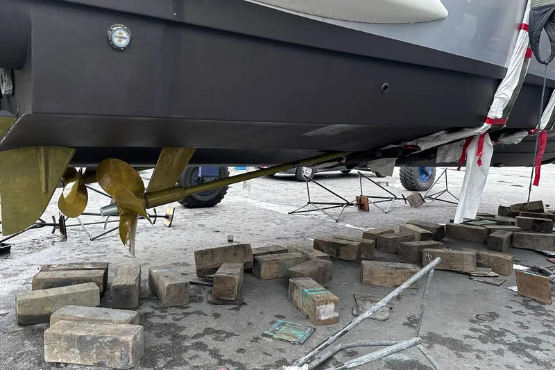  Yacht Photos Pics 2014 Azimut 54 yacht under maintenance, showing propeller and wooden blocks.