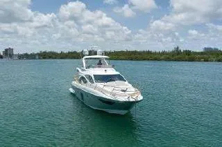  Yacht Photos Pics Luxury 2014 Azimut 54 yacht cruising on clear blue waters under a partly cloudy sky.