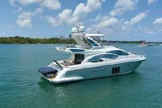  Yacht Photos Pics Luxurious 2014 Azimut 54 yacht cruising on clear blue waters under a sunny sky.