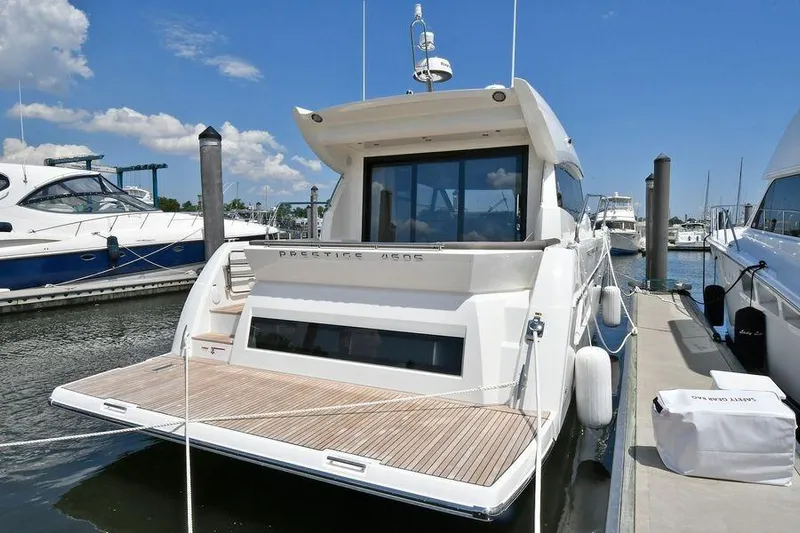  Yacht Photos Pics 2019 Prestige 460 yacht docked at marina under clear blue sky.