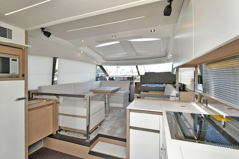  Yacht Photos Pics Luxurious interior of a 2019 Prestige 460 yacht with modern kitchen and seating area.