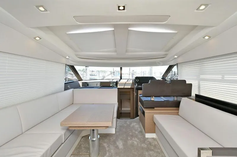  Yacht Photos Pics Luxurious interior of 2019 Prestige 460 yacht with modern seating and dining area.