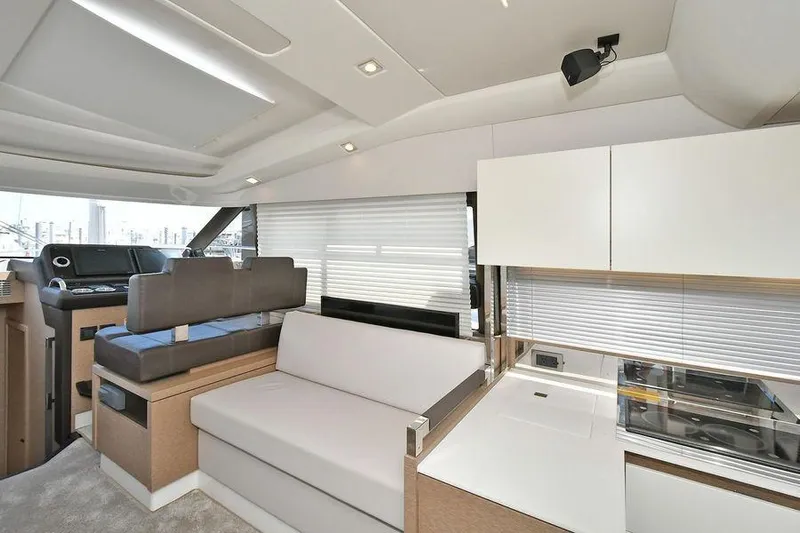  Yacht Photos Pics Luxurious interior of 2019 Prestige 460 yacht with modern seating and kitchen area.