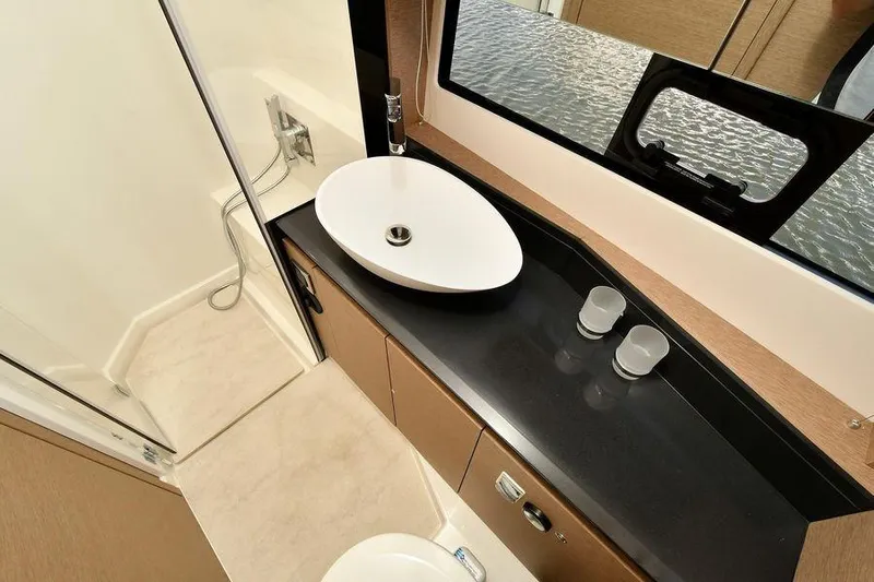  Yacht Photos Pics Luxurious bathroom interior of 2019 Prestige 460 yacht with modern sink and shower.