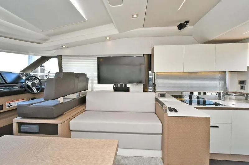  Yacht Photos Pics Luxurious interior of 2019 Prestige 460 yacht with modern seating and sleek kitchen design.