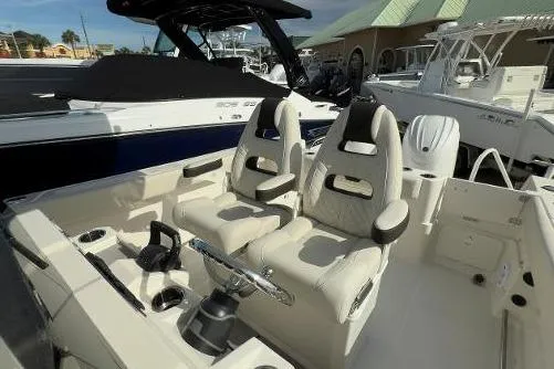 242-935 Yacht Photos Pics 2024 Sailfish 242 CC boat interior with dual captain's chairs and modern design.