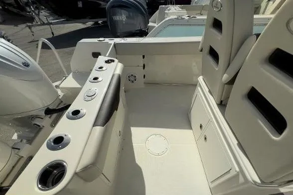 242-935 Yacht Photos Pics 2024 Sailfish 242 CC boat interior with seating and fishing rod holders.