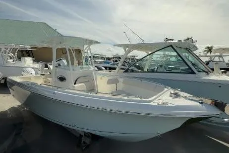 242-935 Yacht Photos Pics 2024 Sailfish 242 CC boat displayed at a marina under a cloudy sky.