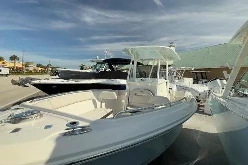 242-935 Yacht Photos Pics 2024 Sailfish 242 CC boat with sleek design, docked under a clear sky.