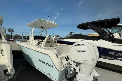 242-935 Yacht Photos Pics 2024 Sailfish 242 CC boat with Yamaha engine, docked outdoors under clear sky.
