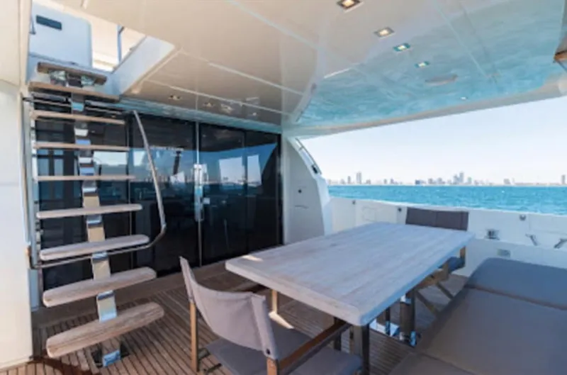The Good Life Yacht Photos Pics Prestige 75 yacht 2015 model, outdoor dining area with ocean view and city skyline.