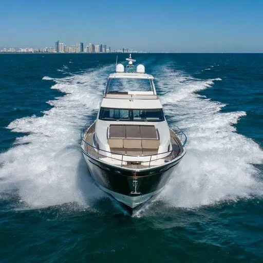 The Good Life Yacht Photos Pics Luxury Prestige 75 yacht cruising in open sea, city skyline in background, 2015 model.