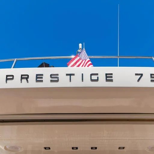 The Good Life Yacht Photos Pics 2015 Prestige 75 yacht with American flag against blue sky