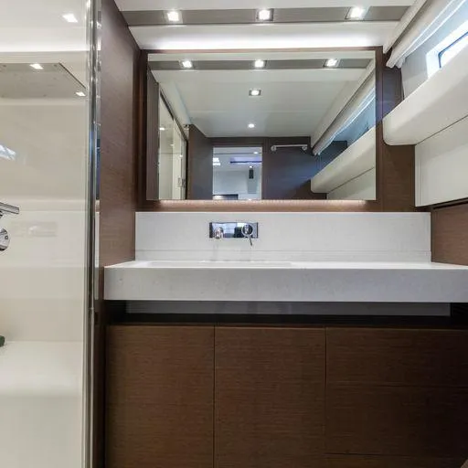 The Good Life Yacht Photos Pics Modern bathroom in a 2015 Prestige 75 yacht with sleek fixtures and large mirror.