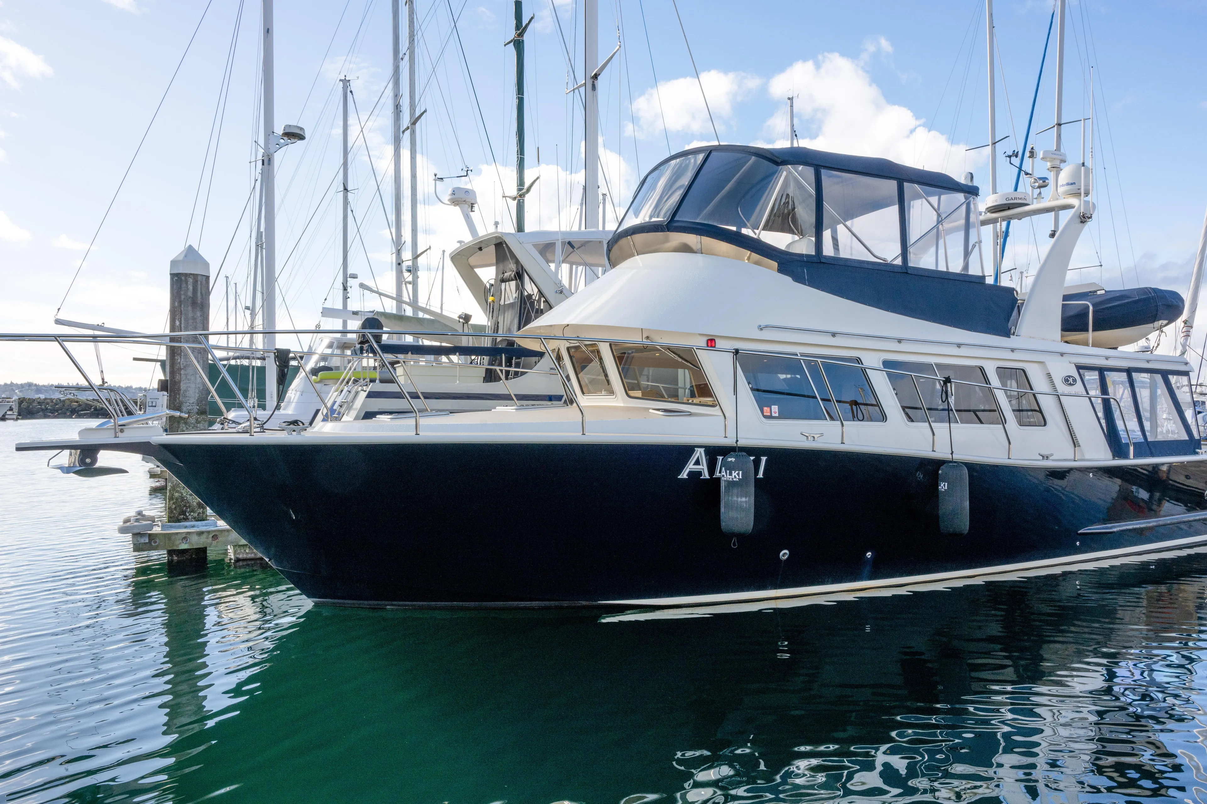 Alki Yacht Photos Pics 2013 Coastal Craft 45 yacht docked at marina, reflecting on calm water.