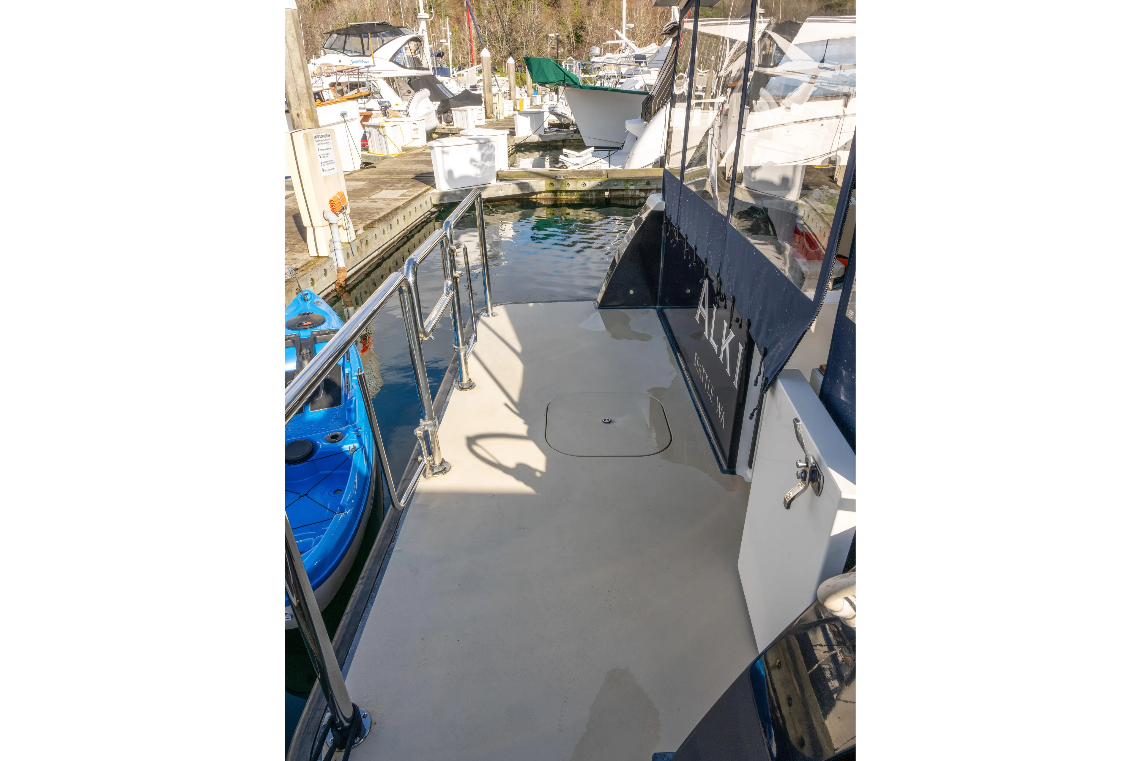 Alki Yacht Photos Pics 2013 Coastal Craft 45 yacht deck at marina, featuring sleek design and stainless steel railings.