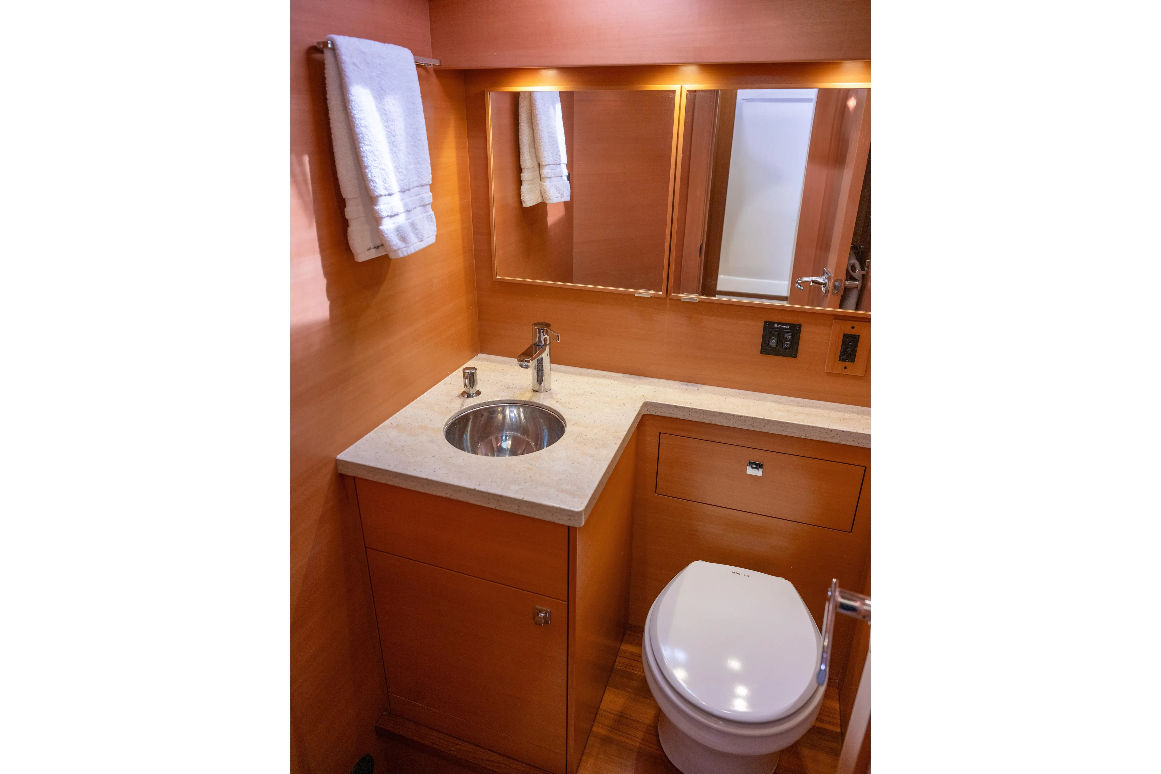 Alki Yacht Photos Pics Luxurious bathroom in 2013 Coastal Craft 45 yacht with modern fixtures and wooden cabinetry.