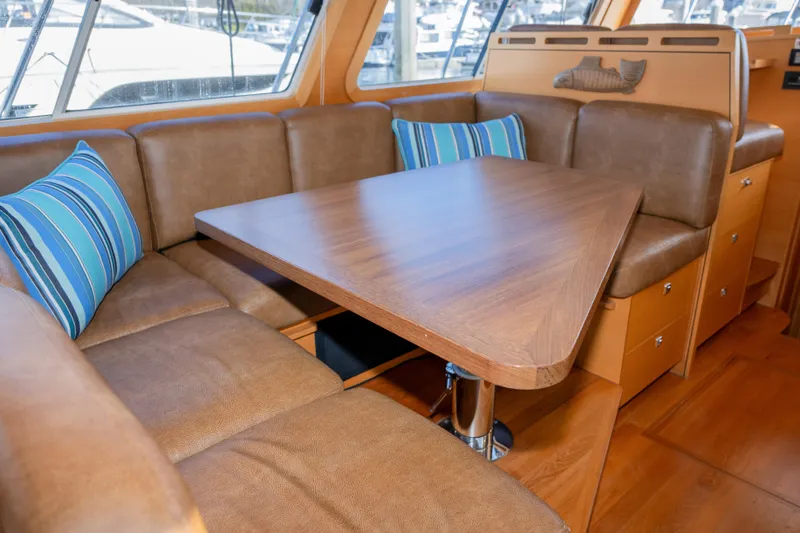 Alki Yacht Photos Pics Luxurious interior of 2013 Coastal Craft 45 yacht with cozy seating and wooden table.