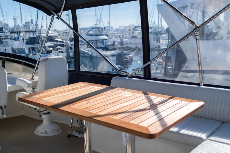 Alki Yacht Photos Pics 2013 Coastal Craft 45 yacht interior with wooden table and marina view.