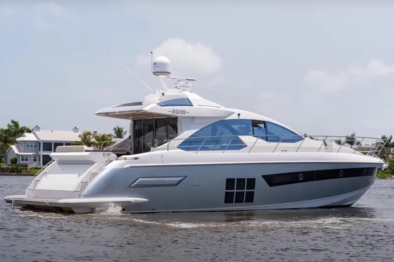 Encore Yacht Photos Pics 2015 Azimut 55S yacht cruising on a calm waterway, with modern design and sleek lines.