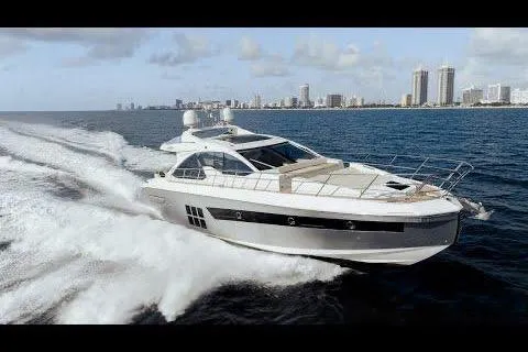 Encore Yacht Photos Pics Azimut 55S 2015 yacht cruising on ocean with city skyline in background.