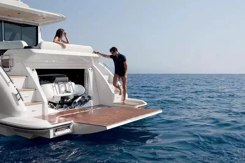 Encore Yacht Photos Pics 2015 Azimut 55S yacht with open swim platform and people enjoying the ocean view.
