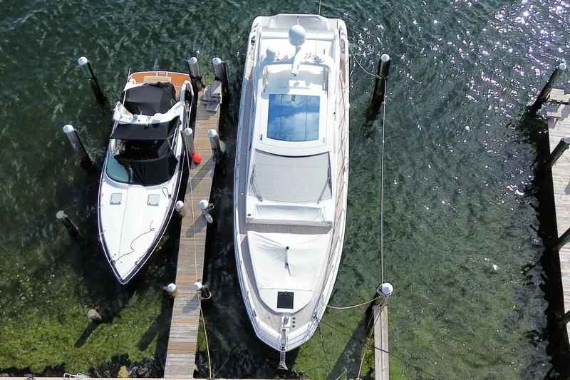 Encore Yacht Photos Pics Aerial view of 2015 Azimut 55S yacht docked beside a smaller boat.
