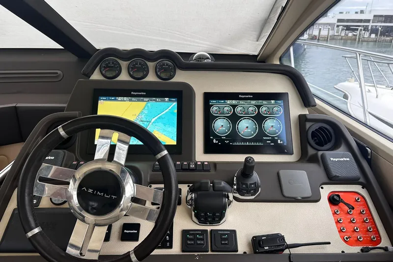 Encore Yacht Photos Pics Cockpit of 2015 Azimut 55S yacht with navigation screens and steering wheel.