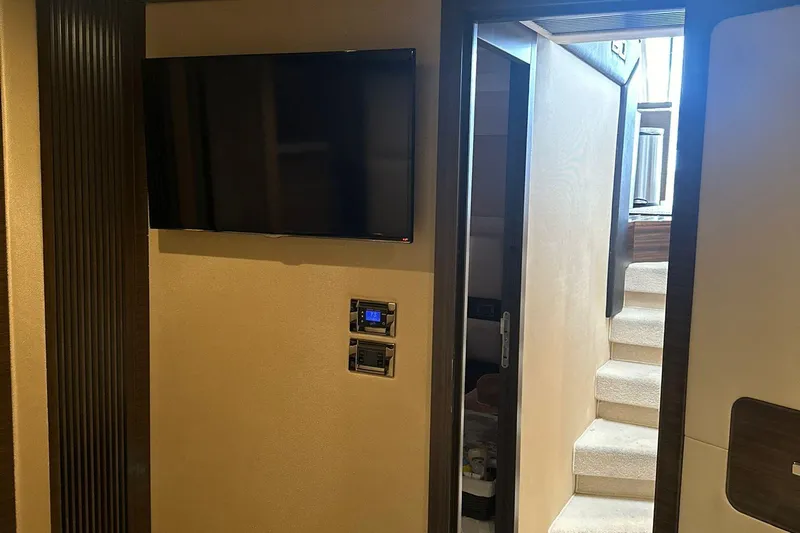 Encore Yacht Photos Pics Interior of 2015 Azimut 55S yacht with wall-mounted TV and staircase.