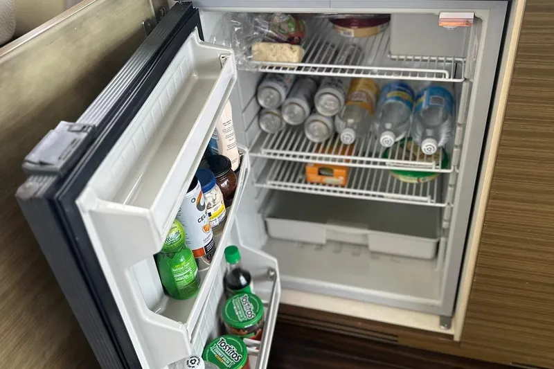 Encore Yacht Photos Pics Open fridge on Azimut 55S yacht, stocked with drinks and condiments, 2015 model.
