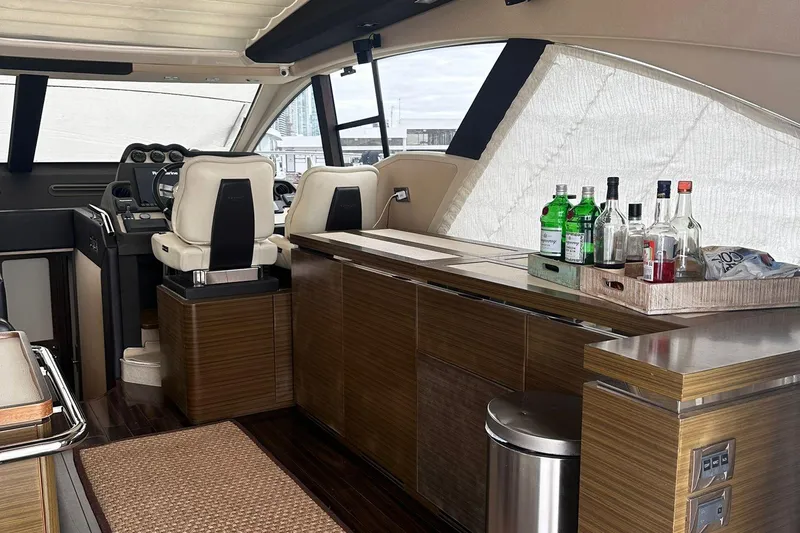 Encore Yacht Photos Pics Luxurious interior of a 2015 Azimut 55S yacht with bar and helm station.