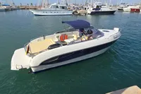 2007 Cranchi CSL 27 boat docked in a marina, featuring a sleek design and blue canopy.