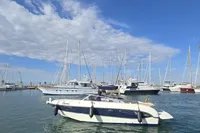 2007 Cranchi CSL 27 boat docked in a marina with sailboats and blue sky.