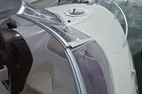 2007 Cranchi CSL 27 boat deck with windshield and hatch, docked on water.