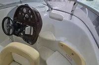 2007 Cranchi CSL 27 boat cockpit with steering wheel and dashboard controls.