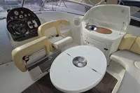 2007 Cranchi CSL 27 boat interior with steering wheel, seating, and kitchenette.