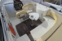2007 Cranchi CSL 27 boat interior with seating, steering wheel, and table.