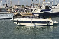 2007 Cranchi CSL 27 boat named Emma docked in a marina with other yachts.