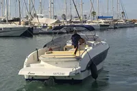 2007 Cranchi CSL 27 motorboat in marina, rear view with person steering.