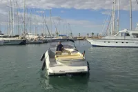 2007 Cranchi CSL 27 motorboat navigating a marina with sailboats and yachts.