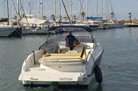 2007 Cranchi CSL 27 boat in marina, rear view with person steering.