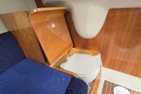 2007 Cranchi CSL 27 cabin interior with wooden paneling and compact toilet.