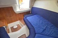 Interior cabin of 2007 Cranchi CSL 27 with blue upholstery and wooden accents.